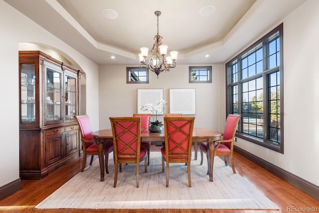 5810 Amber Ridge Dr, Castle Pines, CO 80108 - dining area with a chandelier, a tray ceiling, wood finished floors, baseboards, and recessed lighting