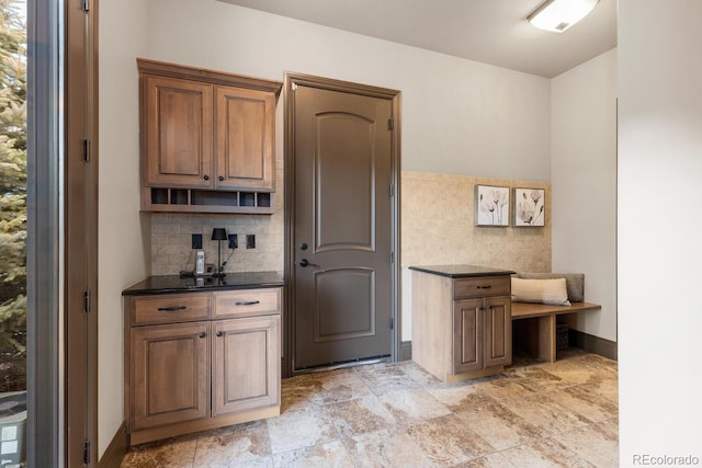 5810 Amber Ridge Dr, Castle Pines, CO 80108 - bar with tasteful backsplash and light stone finish floors