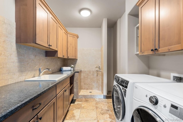 5810 Amber Ridge Dr, Castle Pines, CO 80108 - laundry room featuring cabinet space, washer and dryer, and light stone finish floors