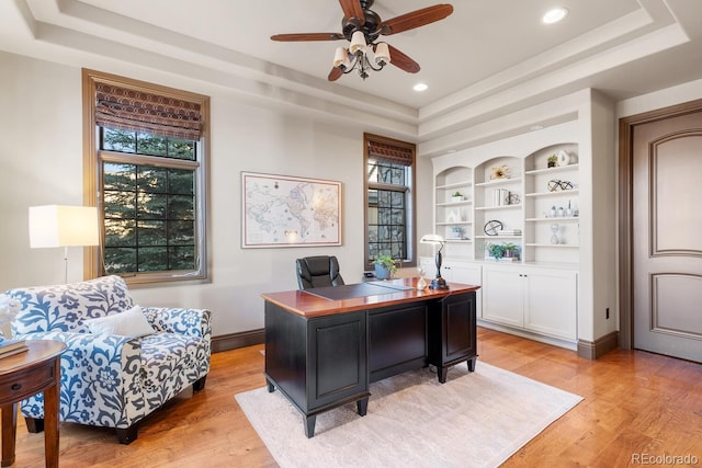 5810 Amber Ridge Dr, Castle Pines, CO 80108 - office area featuring a raised ceiling, light wood-style floors, a ceiling fan, recessed lighting, and baseboards