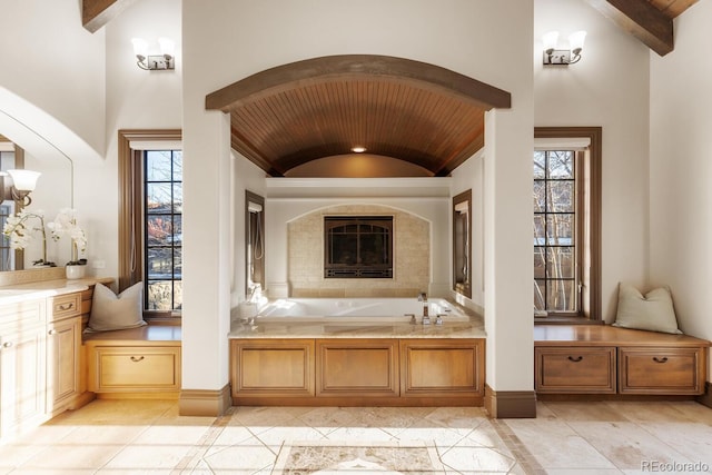 5810 Amber Ridge Dr, Castle Pines, CO 80108 - bathroom with a garden tub, baseboards, a fireplace, and wood ceiling