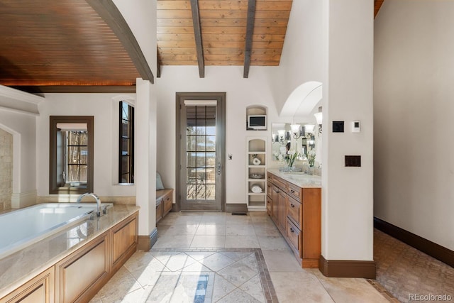 5810 Amber Ridge Dr, Castle Pines, CO 80108 - full bathroom featuring inlaid floor details, vanity, baseboards, wooden ceiling with exposed beams, and a bath