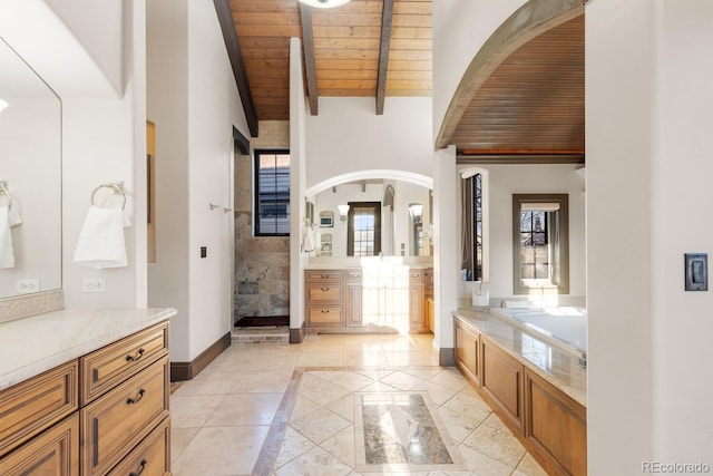 5810 Amber Ridge Dr, Castle Pines, CO 80108 - full bath featuring wooden ceiling with exposed beams, inlaid floor details, two vanities, healthy amount of natural light, and tiled shower