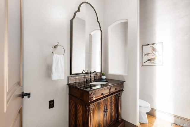 5810 Amber Ridge Dr, Castle Pines, CO 80108 - half bath featuring toilet, vanity, and baseboards