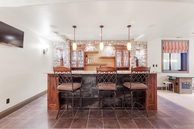 5810 Amber Ridge Dr, Castle Pines, CO 80108 - indoor bar with dark tile patterned flooring, hanging light fixtures, and baseboards