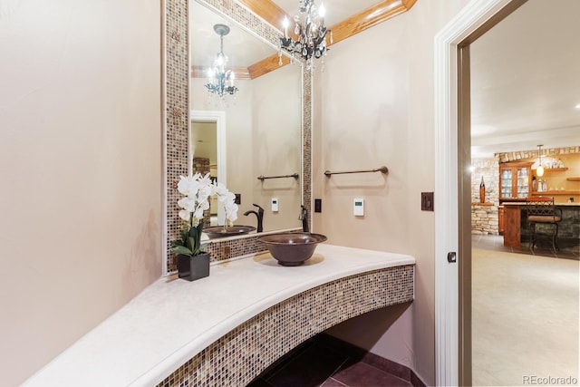 5810 Amber Ridge Dr, Castle Pines, CO 80108 - bathroom featuring a chandelier, vanity, and crown molding