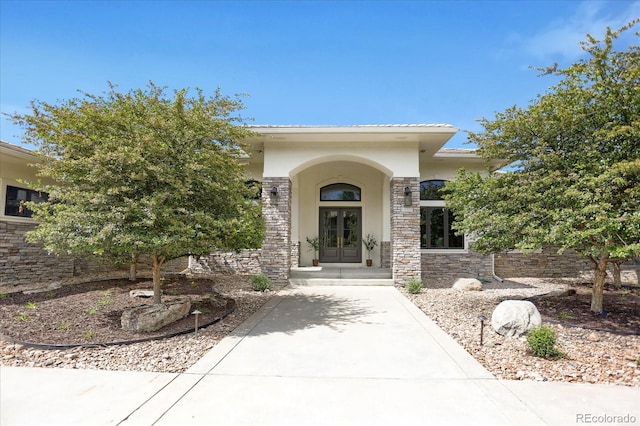 8937 Little Raven Trl, Niwot, CO 80503 - property entrance featuring french doors, stucco siding, and stone siding