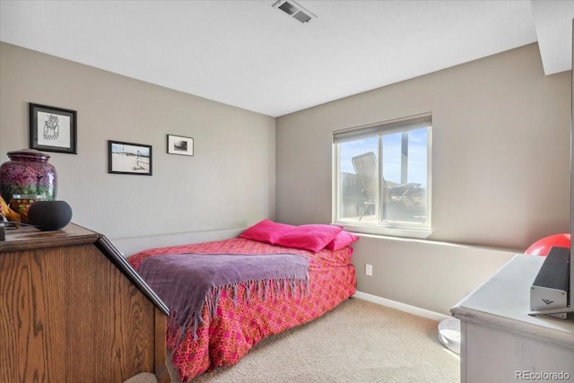 carpeted bedroom with baseboards and visible vents