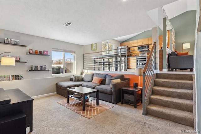 living room featuring lofted ceiling, carpet flooring, visible vents, baseboards, and stairway