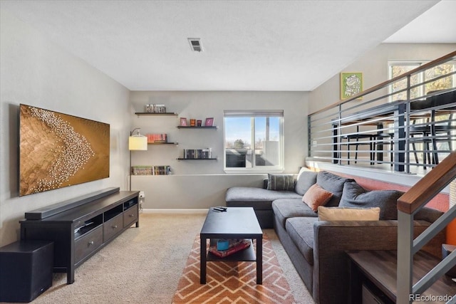 carpeted living room with visible vents and baseboards