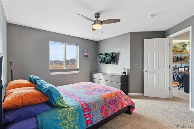 bedroom featuring light carpet, a ceiling fan, and baseboards