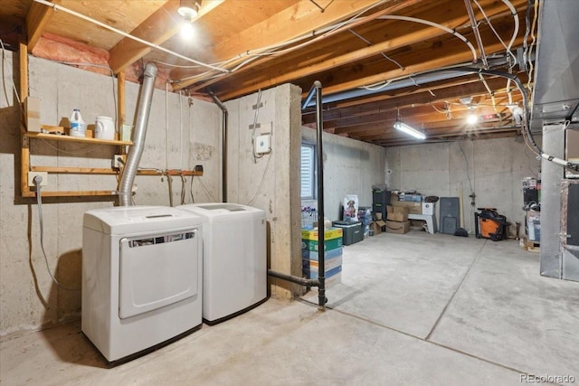 unfinished below grade area with washing machine and clothes dryer