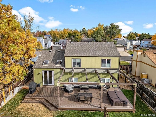 rear view of property featuring a fenced backyard, a residential view, an outdoor hangout area, roof with shingles, and a deck