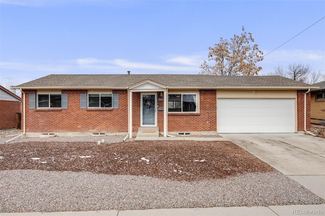 single story home featuring an attached garage, concrete driveway, and brick siding