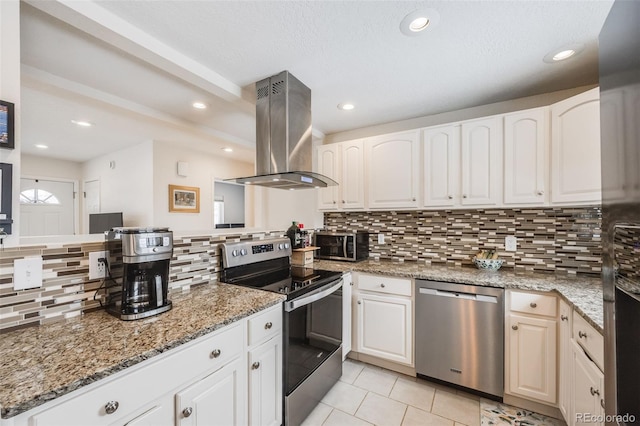 kitchen with appliances with stainless steel finishes, white cabinets, and island exhaust hood