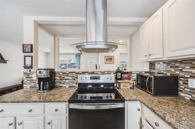 kitchen with white cabinets, decorative backsplash, dark stone counters, appliances with stainless steel finishes, and island exhaust hood