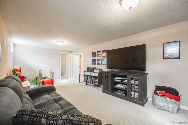 living room featuring carpet floors, baseboards, and a textured ceiling