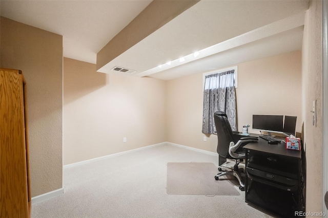 office area featuring visible vents, light carpet, and baseboards