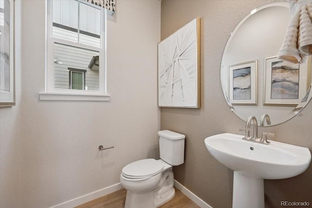 4739 N Valdai Ct, Aurora, CO 80119 - half bath featuring wood finished floors and toilet