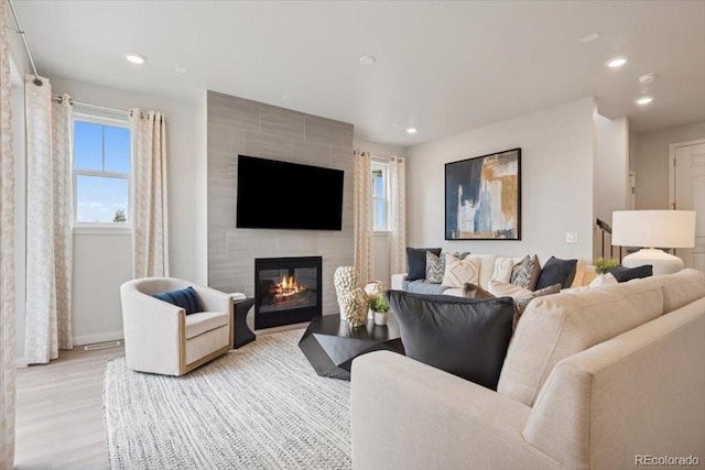 4739 N Valdai Ct, Aurora, CO 80119 - living room featuring recessed lighting, a tile fireplace, and light wood-style floors