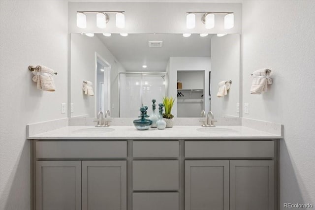 4739 N Valdai Ct, Aurora, CO 80119 - full bath featuring a stall shower, double vanity, and a textured wall