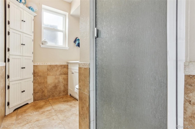 11855 Humboldt Dr, Northglenn, CO 80233 - full bath featuring tile walls, a shower stall, and wainscoting