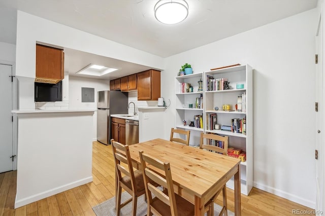 8335 Fairmount Dr Unit 9-201, Denver, CO 80247 - dining space with light wood-style flooring, electric panel, and baseboards