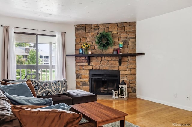 8335 Fairmount Dr Unit 9-201, Denver, CO 80247 - living room with wood finished floors, a fireplace, and baseboards