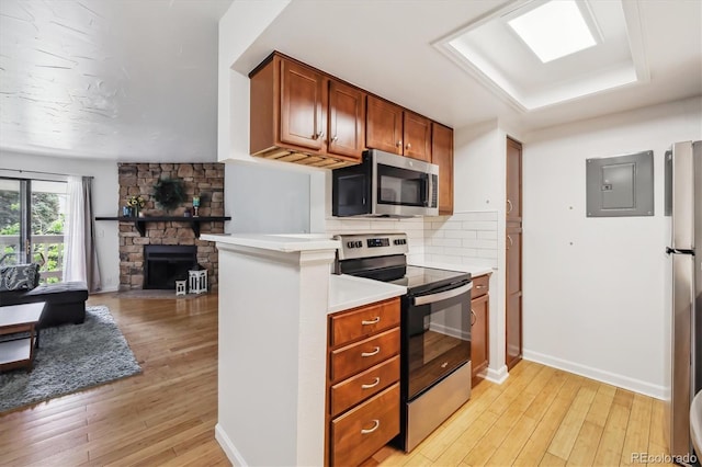 8335 Fairmount Dr Unit 9-201, Denver, CO 80247 - kitchen featuring stainless steel appliances, electric panel, light wood-style flooring, light countertops, and open floor plan