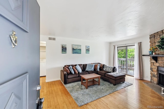 8335 Fairmount Dr Unit 9-201, Denver, CO 80247 - living room with a fireplace, light wood-style flooring, and baseboards