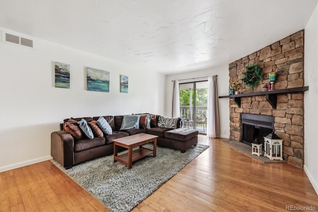 8335 Fairmount Dr Unit 9-201, Denver, CO 80247 - living area with baseboards, wood-type flooring, and a fireplace