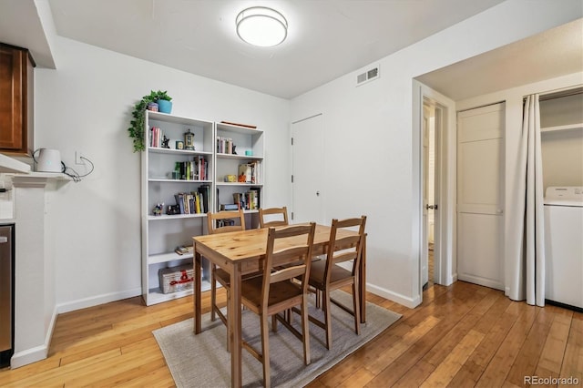 8335 Fairmount Dr Unit 9-201, Denver, CO 80247 - dining room featuring washer / clothes dryer, light wood-type flooring, and baseboards
