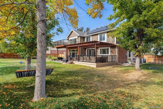 back of property featuring a fenced backyard, a lawn, a pergola, and a patio