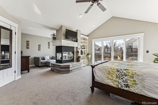 carpeted bedroom featuring access to outside, high vaulted ceiling, a ceiling fan, and a multi sided fireplace