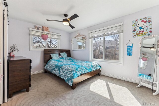 bedroom with a ceiling fan, light colored carpet, and baseboards