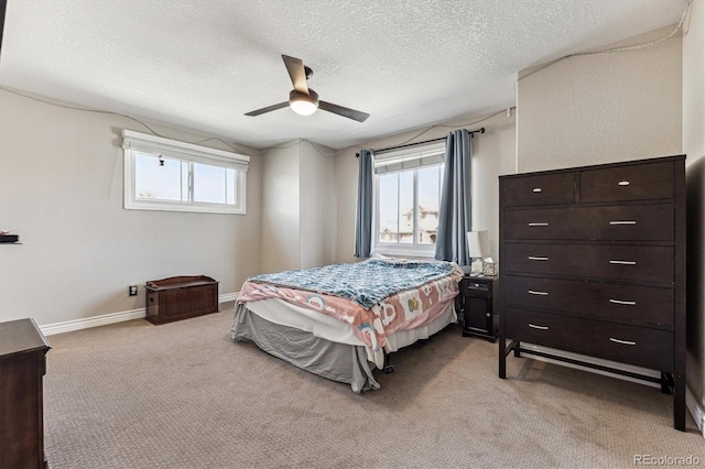 bedroom featuring carpet, ceiling fan, a textured ceiling, and baseboards