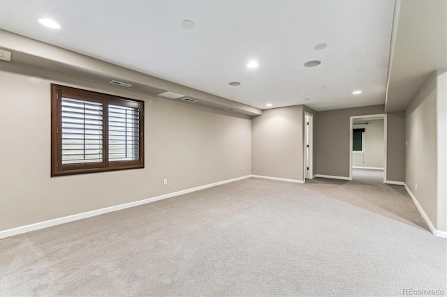 below grade area featuring carpet floors, recessed lighting, visible vents, and baseboards