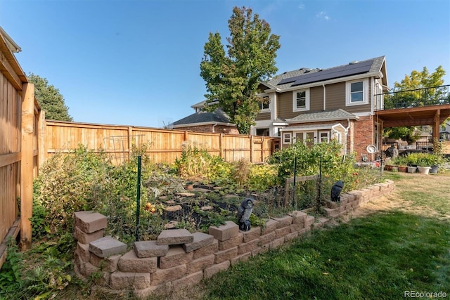 view of yard featuring a fenced backyard and a vegetable garden