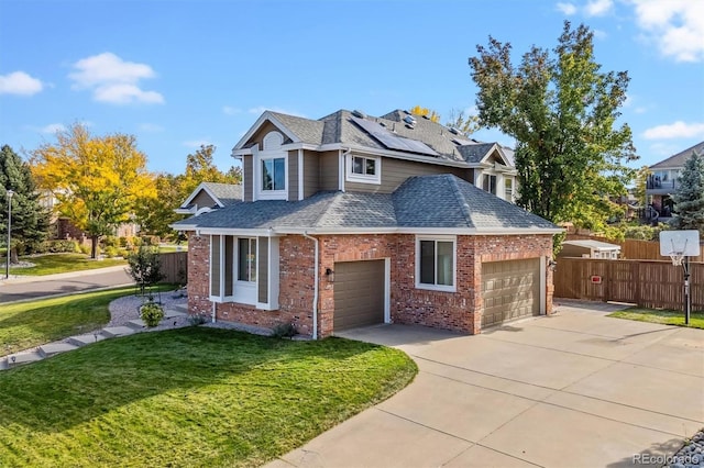 traditional-style house with solar panels, a shingled roof, an attached garage, fence, and a front lawn