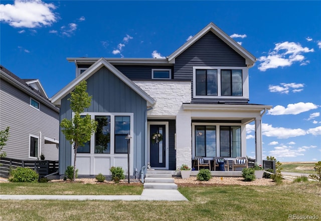 6235 Stable View St, Castle Pines, CO 80108 - view of front of home with a porch and board and batten siding