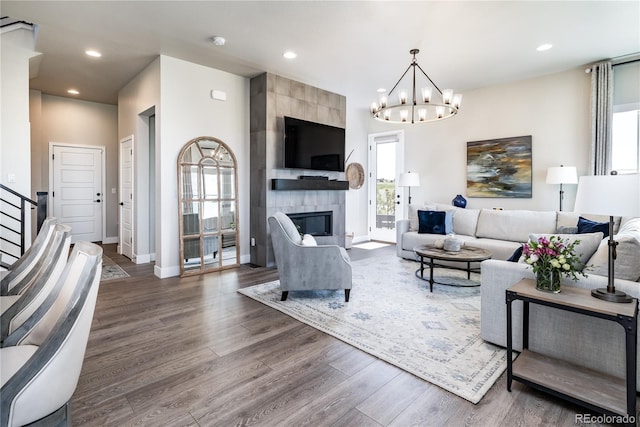 6235 Stable View St, Castle Pines, CO 80108 - living area with wood finished floors, a chandelier, a fireplace, recessed lighting, and stairs