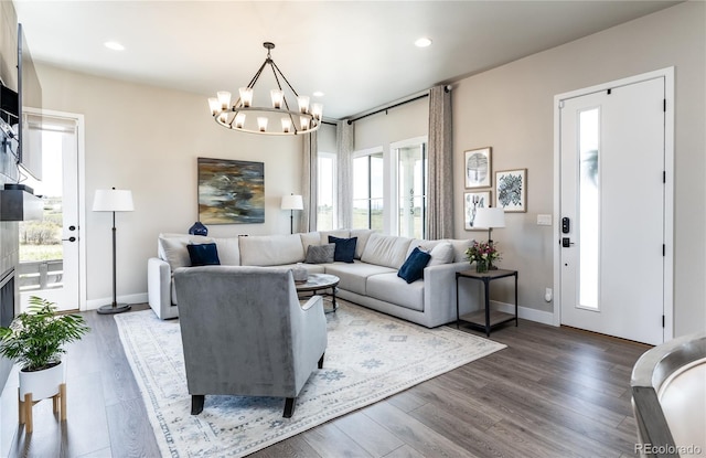 6235 Stable View St, Castle Pines, CO 80108 - living room featuring a chandelier, recessed lighting, and wood finished floors