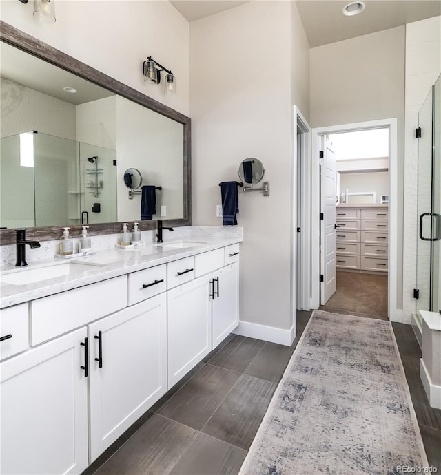6235 Stable View St, Castle Pines, CO 80108 - full bathroom featuring double vanity, a shower stall, and a spacious closet