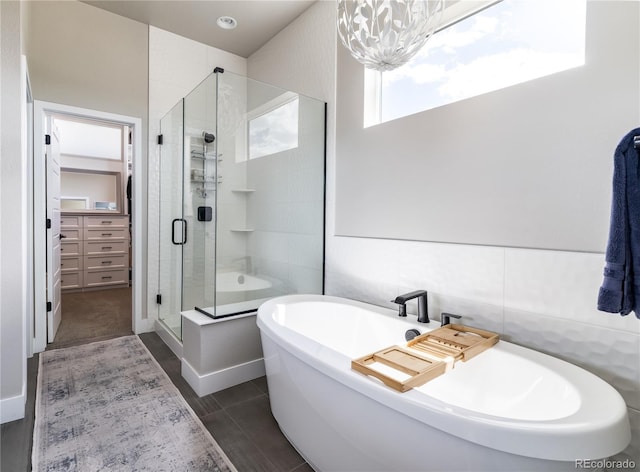 6235 Stable View St, Castle Pines, CO 80108 - bathroom with a freestanding tub, a shower stall, a chandelier, and a spacious closet