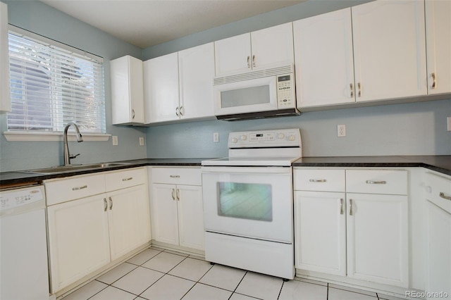 kitchen with white appliances, white cabinetry, light tile patterned floors, and sink