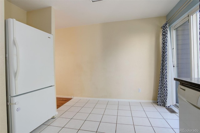 kitchen featuring white appliances and light tile patterned floors