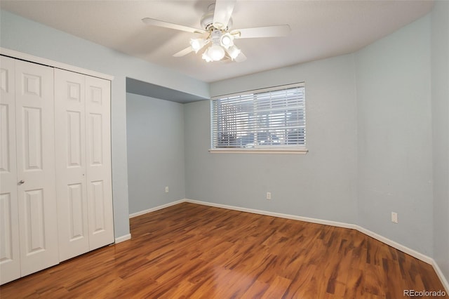 unfurnished bedroom with a closet, ceiling fan, and wood-type flooring