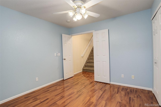 unfurnished room with ceiling fan and wood-type flooring