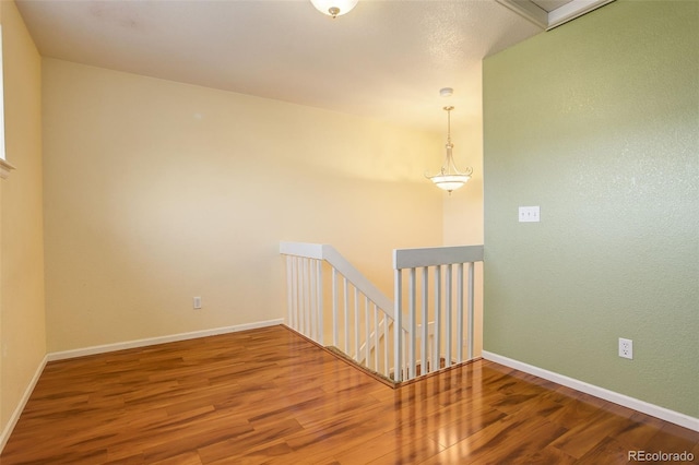 empty room with hardwood / wood-style floors