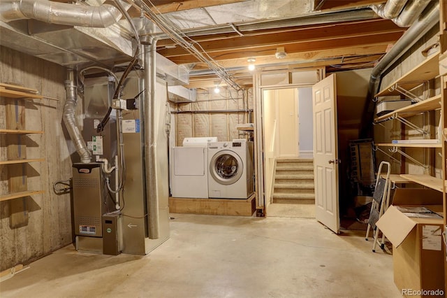 basement with washing machine and dryer and heating unit